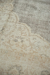 Distressed texture of vintage Oushak carpet, showing blanched ivory and muted earth tones.