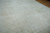 Modern style distressed Oushak carpet, showcasing faded beige pile with subtle pattern variations.