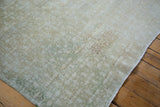 Modern style distressed Oushak carpet, faded beige and muted green pile with subtle medallions.