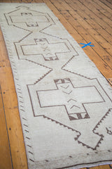 Distressed vintage Turkish Oushak runner with geometric medallion pattern.