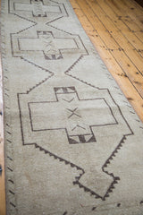 Distressed ivory and brown geometric design of a vintage Oushak runner.