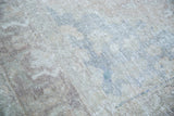 Distressed Oushak carpet texture with softened tans, charcoal, and subtle coral tones.
