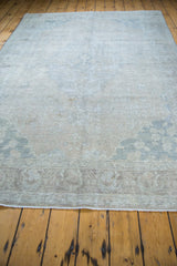 Distressed surface of a vintage Turkish Oushak carpet with soft coral, silver, and tan tones.