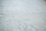 Decorative distressed texture with soft coral, silver, and charcoal on this Oushak rug.