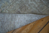 Robust woven foundation and the distressed pile of a vintage Turkish Oushak carpet.