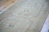 Distressed vintage Oushak runner detail, with faded blanched tones and geometric pattern.