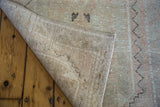 Distressed Oushak runner, showing blanched pile and tightly woven, striped foundation.