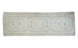 Distressed Oushak runner featuring three panels in blanched silver, coral, and charcoal.
