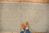 Blanched distressed Kaisary runner texture with allover scrolling vines underfoot.