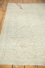 Blanched, airy texture with subtle scrolling vines and border on the distressed Turkish Oushak runner.