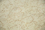 Blanched pile texture with faded scrolling vines on a distressed Oushak rug.