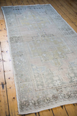 Faded geometric patterns and distressed texture on a vintage Oushak rug.