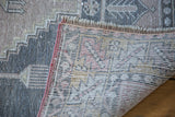 Distressed Oushak rug pile shows its hand-knotted foundation and fringe.