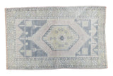 Distressed Vintage Oushak rug in soft apricot mauve with gold and charcoal geometric patterns. 3'5