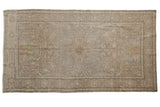 Distressed vintage Turkish Oushak runner, sprawling medallion, faded ivory and soft blue.