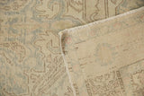 Textured, faded pile of the distressed Turkish Oushak rug, showing its woven reverse.