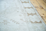 Worn texture and geometric motif on distressed Oushak rug in tone-on-tone cream and tan.