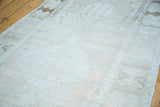 Soft, worn texture and faded tone-on-tone beige geometric motifs on an Oushak rug.