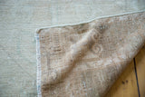 Oushak rug runner reverse, showing woven foundation and distressed, worn pile.