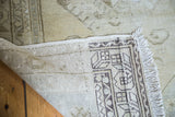 Reverse side of the distressed Oushak rug, highlighting geometric motifs and fringe.