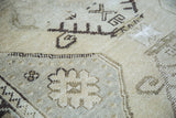 Distressed pile texture of vintage Turkish Oushak rug with faded beige and charcoal patterns.