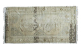 Distressed vintage Oushak rug; faded double medallion on beige, charcoal, and bronze, 3'9