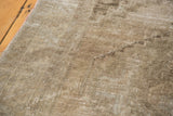 Hand-knotted distressed Oushak rug pile with soft sandy earth tones and worn texture.