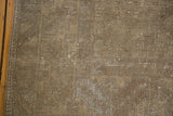 Visible distressing and worn texture of the Oushak rug in soft sandy earth tones.