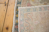 Hand-knotted foundation and distressed pile texture with blanched pastel tones.
