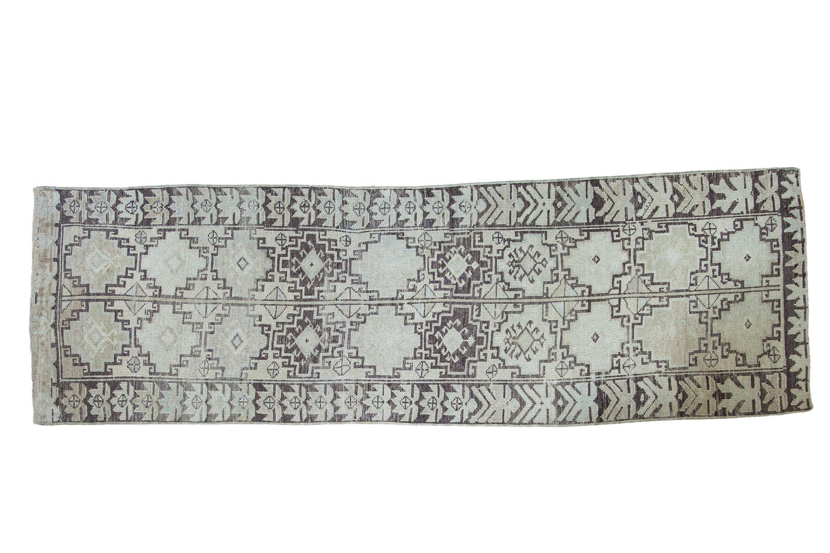 Distressed vintage Oushak runner, ivory field, charcoal geometric medallions. 2'10" x 9'3".