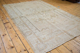 Vintage distressed Oushak rug showcasing light wooded, saffron gold, and near white tones.