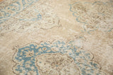 Close-up of the distressed Oushak runner's faded teal and softened rose scalloped pattern.