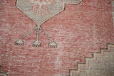 Distressed Oushak runner with cinnabar red field and geometric slate grey design detail.