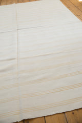 Bleached ivory dhurrie flatweave with fine gold stripes and professionally sewn seam.
