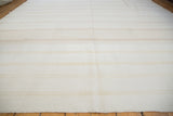 Finely woven dhurrie cotton texture with bleached ivory, beige, and platinum stripes.