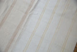 Professionally seamed dhurrie flatweave, showing finely woven repurposed cotton in ivory and beige.
