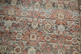 Vintage Malayer runner detail showing distressed brick red and slate blue Herati pattern.