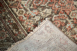 Vintage Malayer runner's corner, showing hand-knotted foundation and distressed pile.