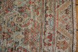Distressed slate blue and brick red Herati design with meandering border and fringe.
