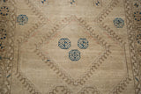 Minimalist geometric pattern of the vintage Konya runner, featuring beige, brown-bronze, and dark blue.