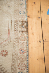 Geometric border detail of a vintage Konya runner in beige, brown bronze, and blue.