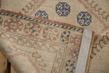 Hand-knotted back and edge of vintage Konya runner, revealing beige field with geometric blue, red motifs.