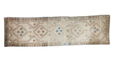 Vintage Konya hand-knotted runner featuring geometric diamonds in beige, brown, and blue.