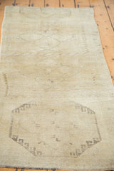 Vintage Oushak runner with a subtle medallion motif in calming creamy beige, revealing hand-knotted texture.