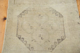 Subtle geometric medallion pattern on the creamy beige hand-knotted Oushak runner.