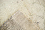 Hand-knotted construction of the vintage Oushak runner, showing its creamy beige pile and detailed back.