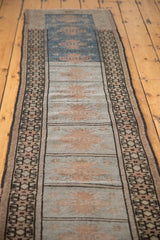 Vintage Oushak runner with geometric border, blue and grey panels, faded peach motifs.