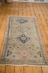 Distressed Oushak runner with dusty grey field, terra cotta, and tarnished navy geometric motifs.