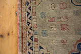 Distressed Oushak runner showing textured dusty grey pile with terra cotta and tarnished navy.