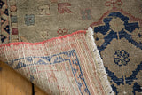 Distressed Oushak runner, showing its hand-knotted reverse, dusty grey, navy, and terra cotta colors.